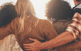 Group of people comforting each other