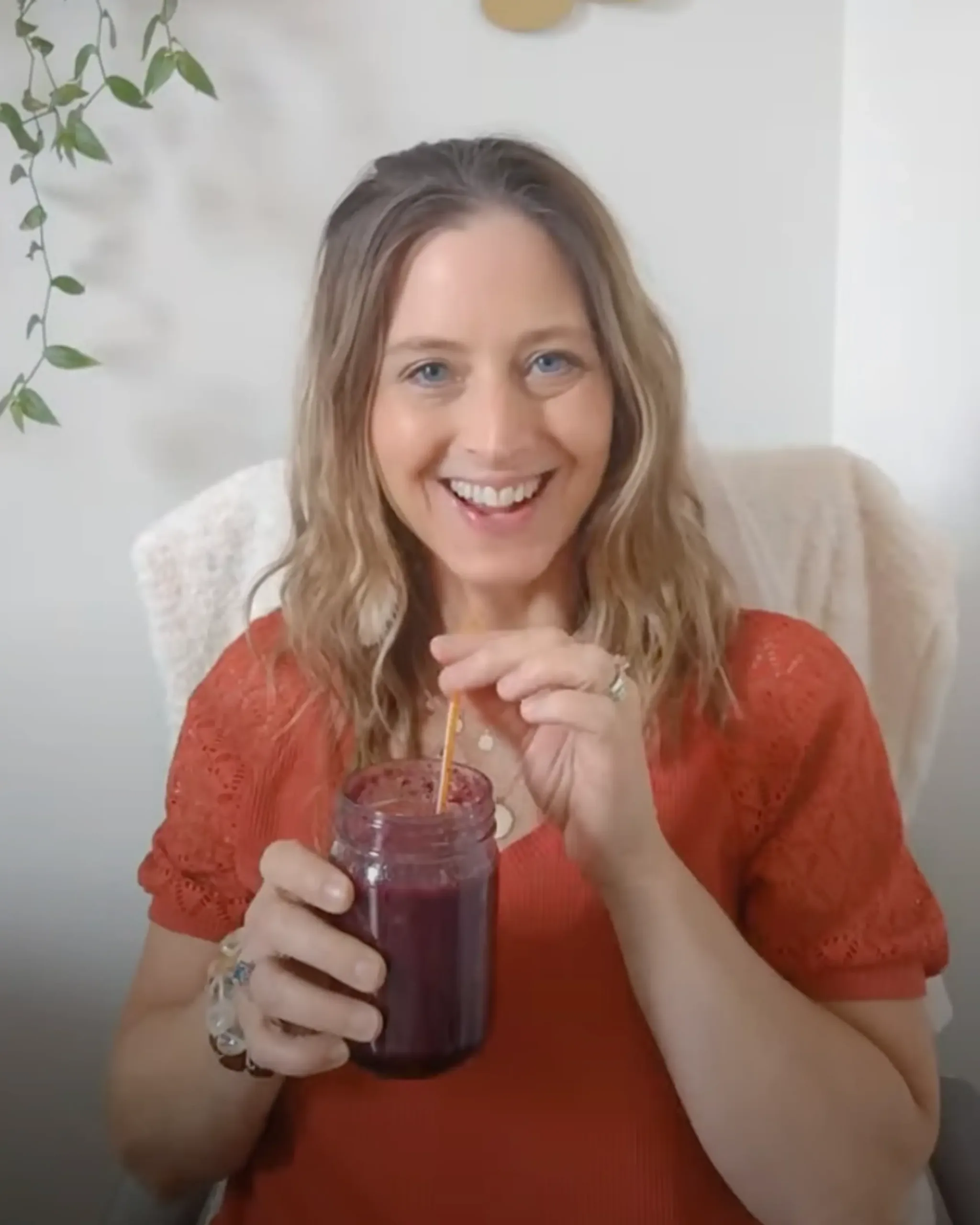 Angie smiling while holding a glass of juice